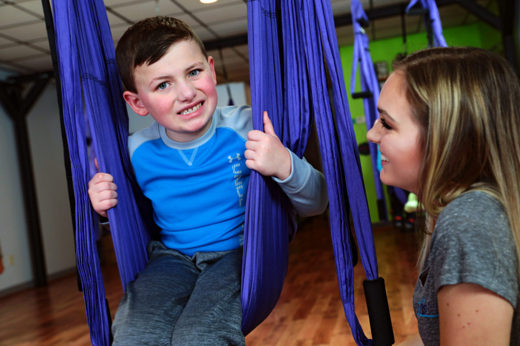 Boy smiling on hammock