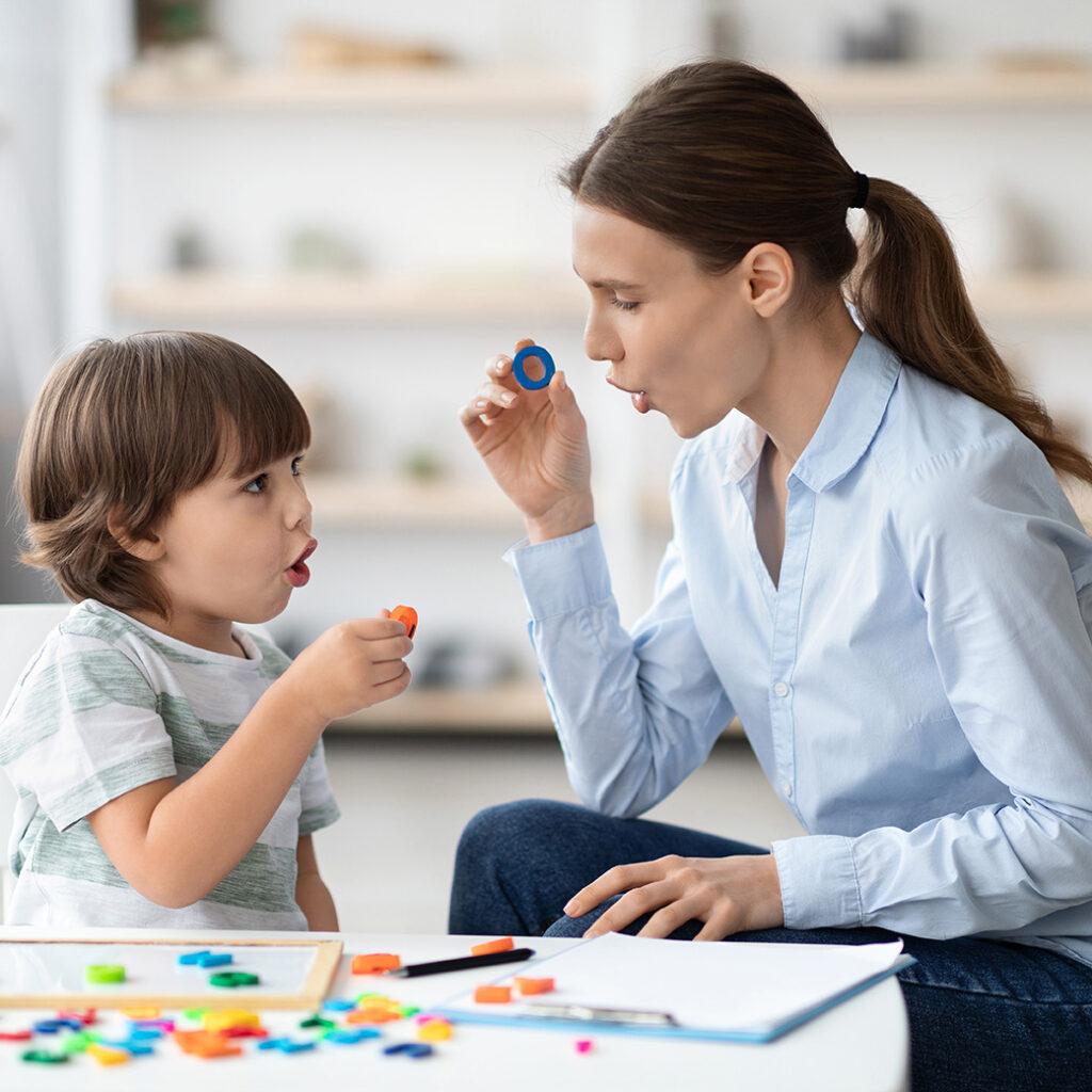 Language therapist working with boy