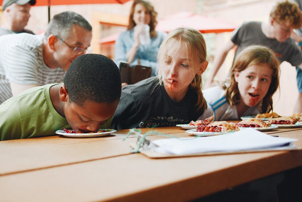 Children eating pie without utentsils