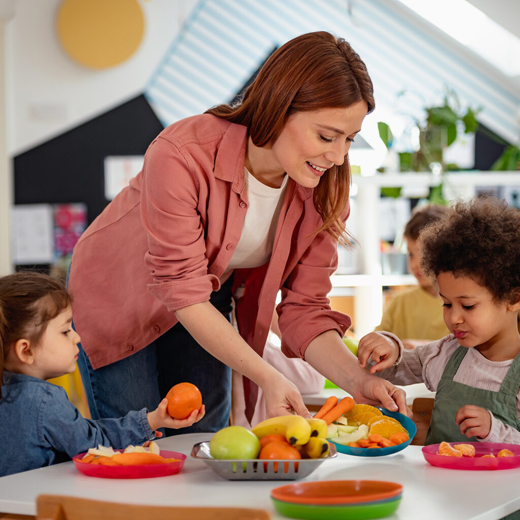 Woman serving food to children