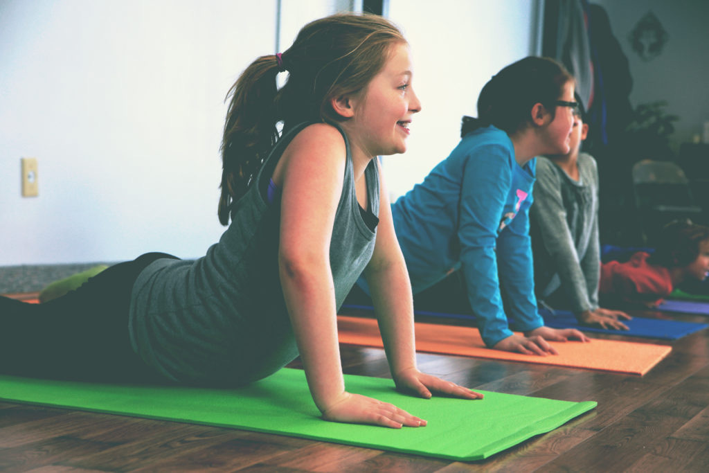 Students stretching on colorful mats