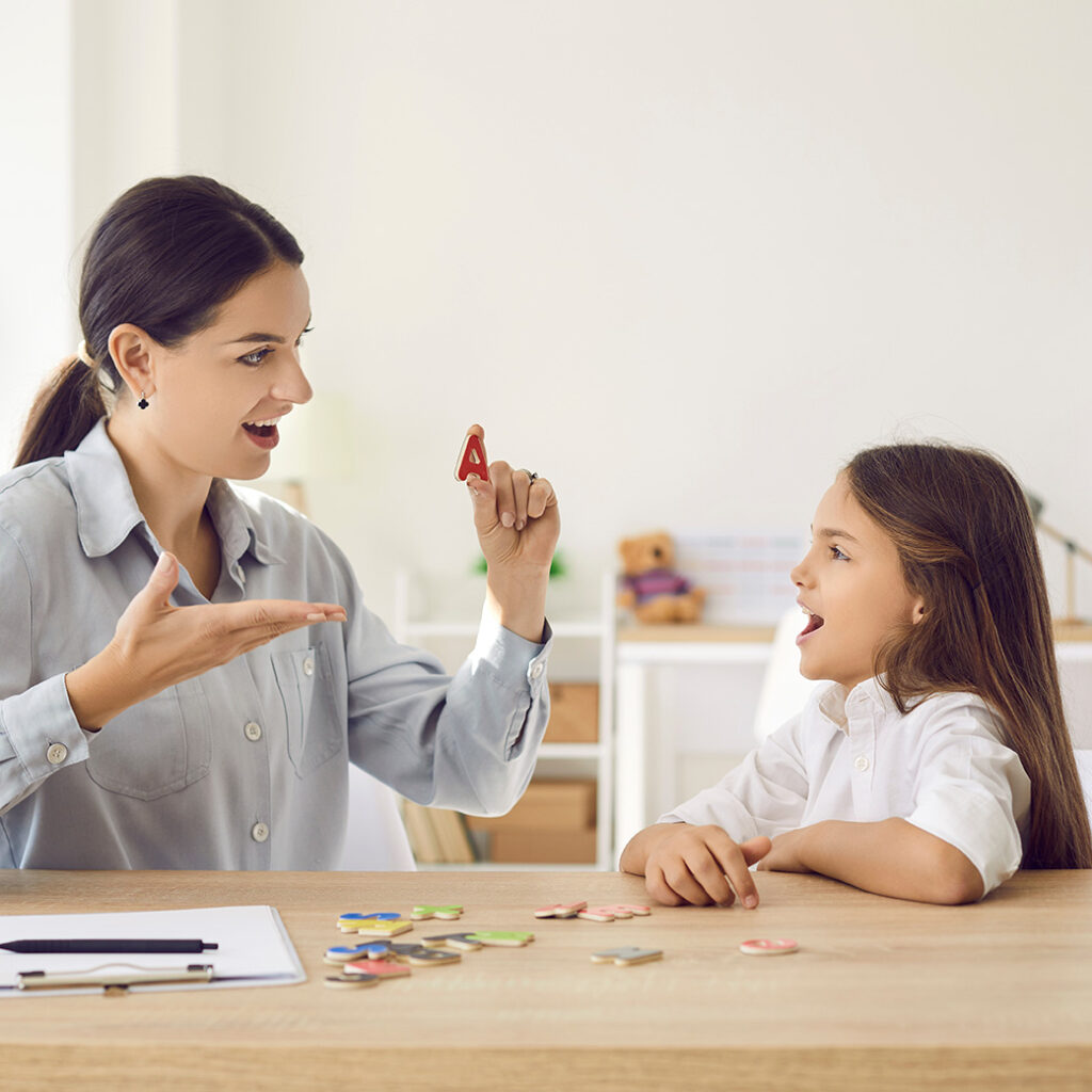 Woman assisting child with speech and language