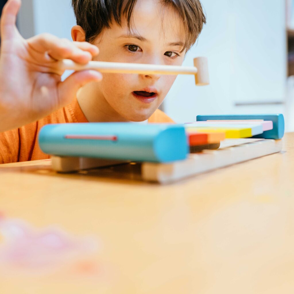 Autistic boy playing with xylophone