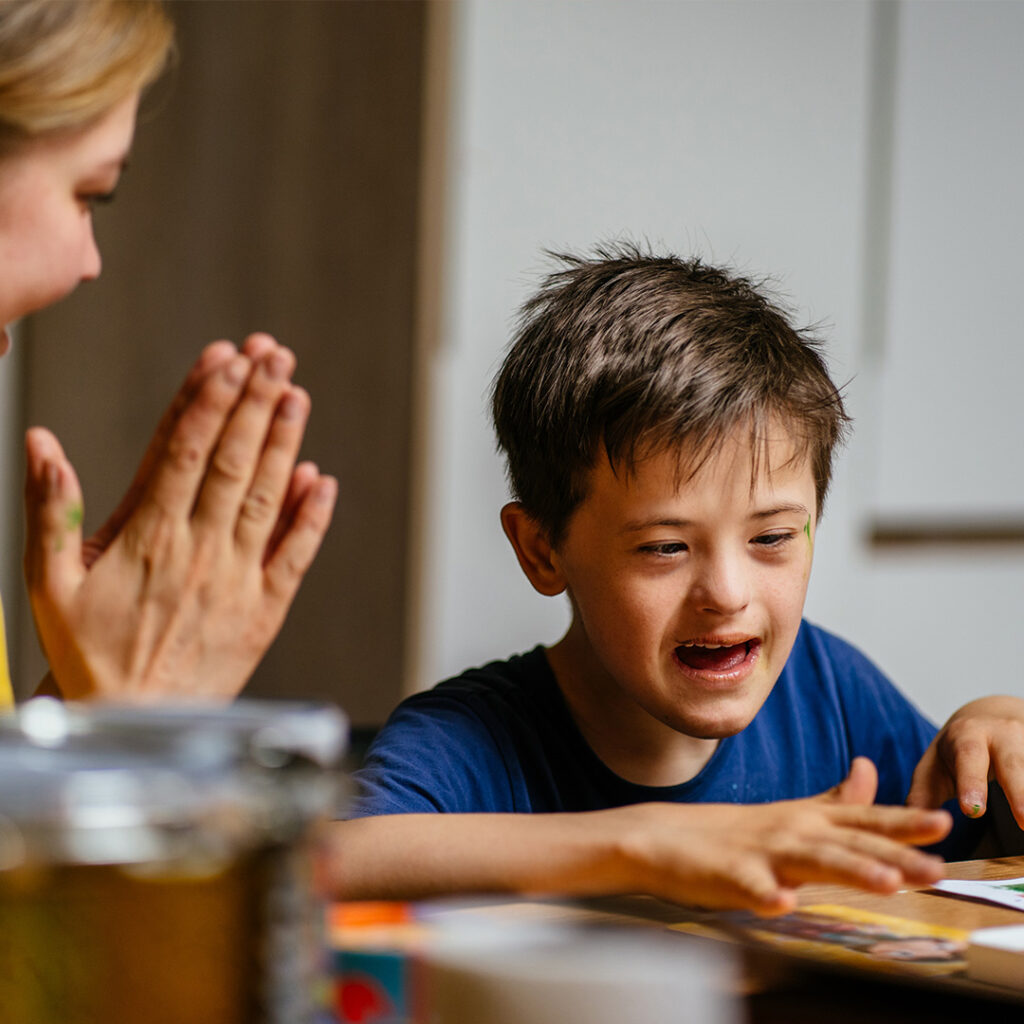 Child with autism working with academic intervention specialist