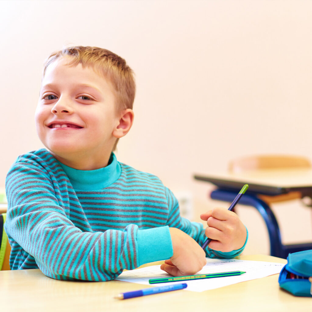 Little boy wearing striped shirt smiling